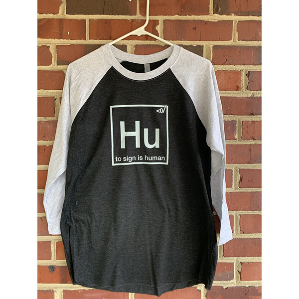 black and white long-sleeved shirt, white design. "Hu - to sign is human".
