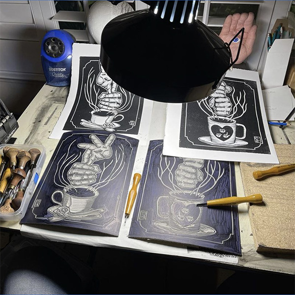 Shot of David Call's linocut work in progress; picture shows "Tea" and "coffee" linocut and print