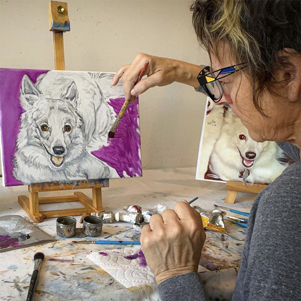 Kelly Simpson doing an oil paint of a small dog. The background on the picture is purple, the dog is in pencil and has not been colored in.